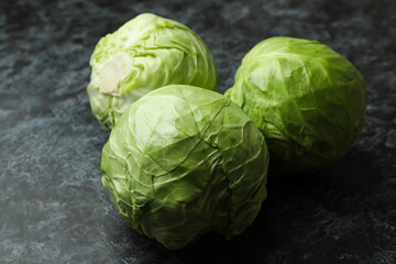Fresh green cabbage on black smoky background
