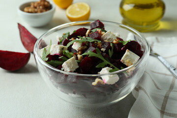 Concept of tasty eating with beet salad on white textured background