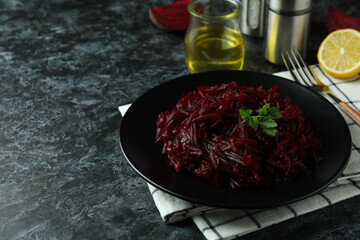 Concept of tasty eating with beet salad on black smoky table