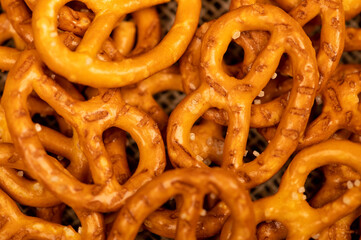 Salted breadsticks and salted pretzels scattered on the table.
