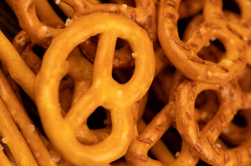 Salted breadsticks and salted pretzels scattered on the table.
