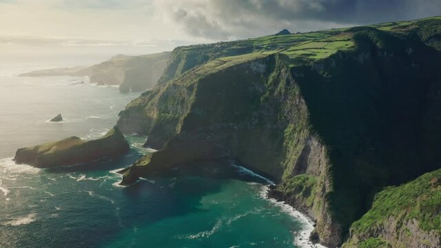 Casa do Gato Tomas, Flores Island, Azores, Portugal. Picturesque sunrise in coastal countryside. Aerial view of the Jurassic jungle natural landscape. High quality 4k footage