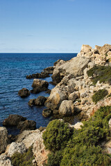 Fototapeta na wymiar Rocks at Prajjet Bay or Anchor Bay in Popeye Village on a warm fall day in Malta.