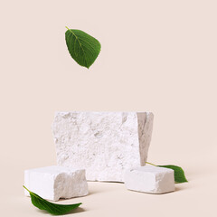 Natural organic cosmetic product presentation. Stone podium elements with green leaves falling. 3d rendering