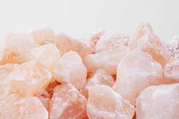 Fototapeta na wymiar Rose aroma himalayan salt healthy spa cut crystals macro with light background