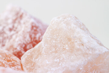 Rose aroma himalayan salt healthy spa cut crystals macro with light blur background