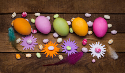 Obraz na płótnie Canvas beautiful Easter eggs with ornaments on a rustic background lay flat