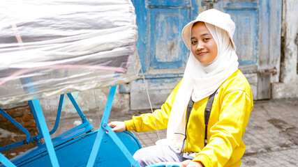 Asian women travel in rickshaws wearing jilbab and analog camera