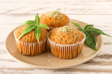 Cupcake with marijuana. Tasty cupcake muffins with cannabis weed cbd. Medical marijuana drugs in food dessert, ganja legalization.