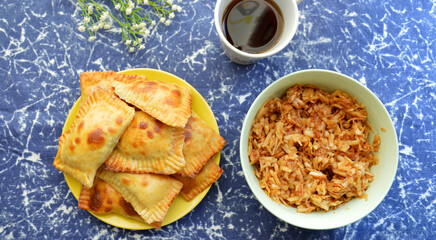 on a blue background a mug of tea, homemade cakes and grated apple filling for pies