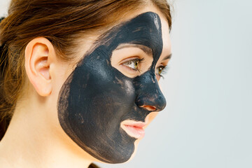 Woman with charcoal facial mask