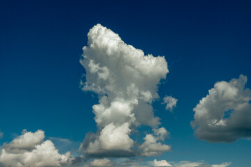 Cumulus clouds in a blue sky.