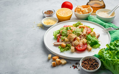 Caesar salad with croutons on a gray background.