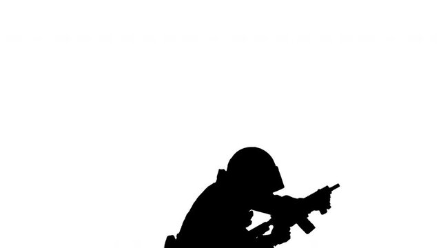 Silhouette Special forces unit shooting from sitting position.