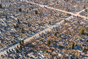 Aerial view of huge urban cemetery with grid layout. Increase in the scale of the cemetery due to...