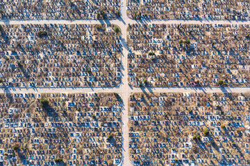 Aerial view of huge urban cemetery with grid layout. Increase in the scale of the cemetery due to...