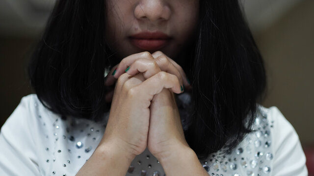 a Christian woman praying humbly in church