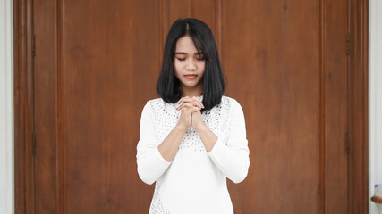 Fototapeta premium a Christian woman praying humbly in church