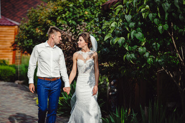 Bride and groom are walking in the park