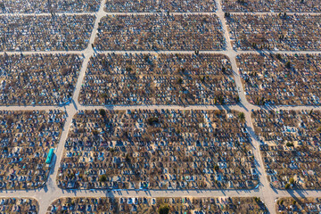 Aerial view of huge urban cemetery with grid layout. Increase in the scale of the cemetery due to...