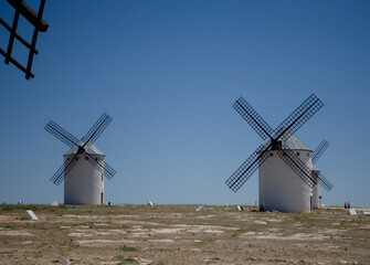 Two windmills in a typical landscape of La Mancha in Spain
