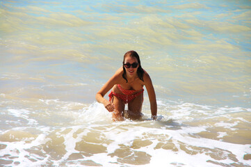 Young woman having fun in stormy sea