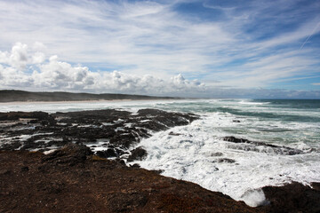 Beautiful ocean rocky coastline, clouds on the blue sky, no people