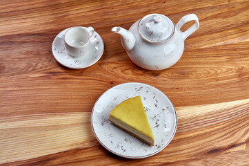 a piece of cheesecake on a plate on a wooden background background