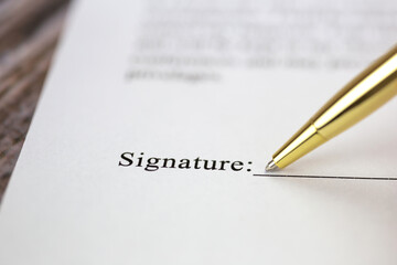 Signing a contract with signature with gold pen macro close-up, businessman,contract,deal,concept background