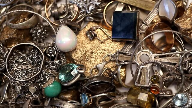 Pile of silver and gold jewelry with jewels rotating 4K