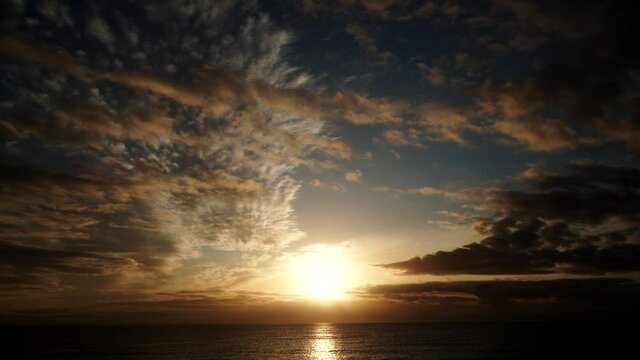 Seascape at early morning, first light. Time lapse of clouds moving over sea and sun rising. Nature landscape in Spain.