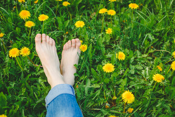 Relaxing girl lying on the spring blooming meadow