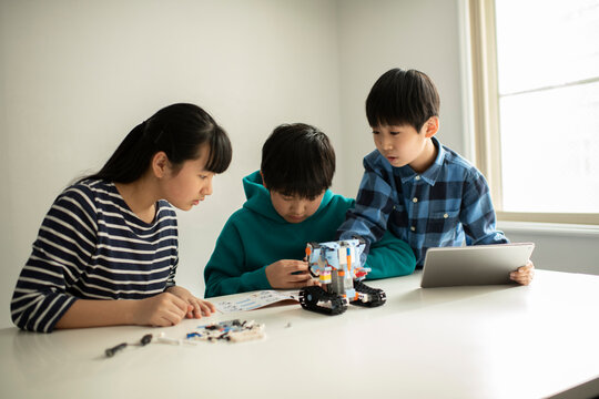 Elementary School Students Assembling Programming Robot