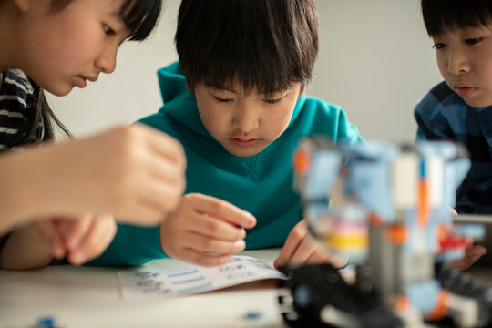 Elementary School Students Assembling Programming Robot