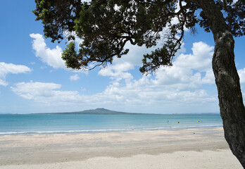 Summer at Takapuna beach with views of Rangitoto Island and people playing on the beach, North Shore, Auckland