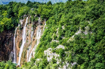 Fototapeta na wymiar Fantastic waterfalls in green forest background, good for wallpaper
