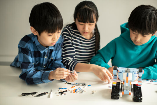 Elementary School Students Assembling Programming Robot