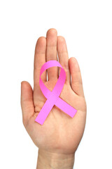 Pink ribbon in female hands isolated on white, breast cancer struggle symbol. Vertical orientation