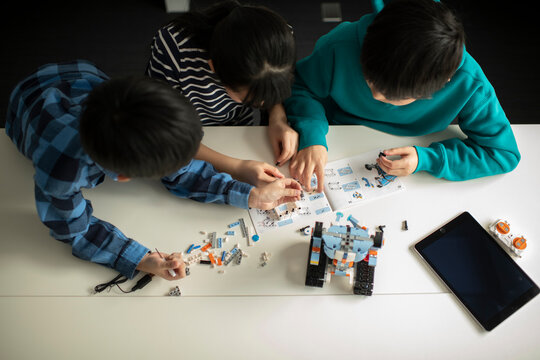Elementary School Students Assembling Programming Robot