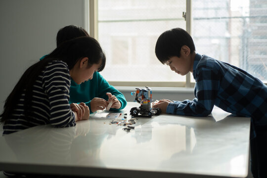 Elementary School Students Assembling Programming Robot