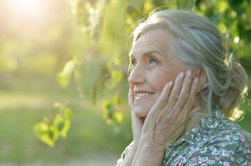  senior beautiful woman posing  in   park