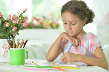  cute girl drawing picture  at home