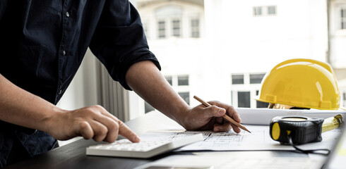 The home design architects are reviewing the house plan draft, the project commissioned by the client, and the custom design before delivery. Interior design and decoration ideas.