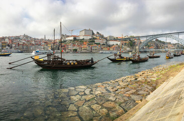 Porto, Portugal old town cityscape on the Douro River with traditional Rabelo boats