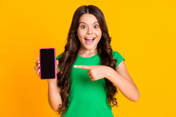 Photo of happy smiling good mood excited girl point finger smartphone advertisement isolated on...