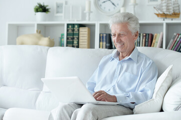  senior man using laptop  at home