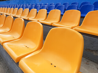 Empty rows with blue and yellow seats in the stadium