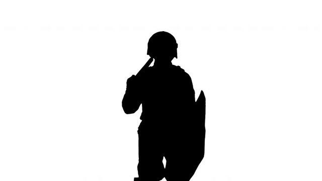 Silhouette Riot policeman standing and doing nothing waiting.