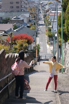 Mother and daughter playing on the stairs