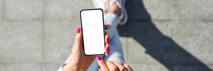 Panoramic photo of woman using mobile phone with blank white screen - 422946205